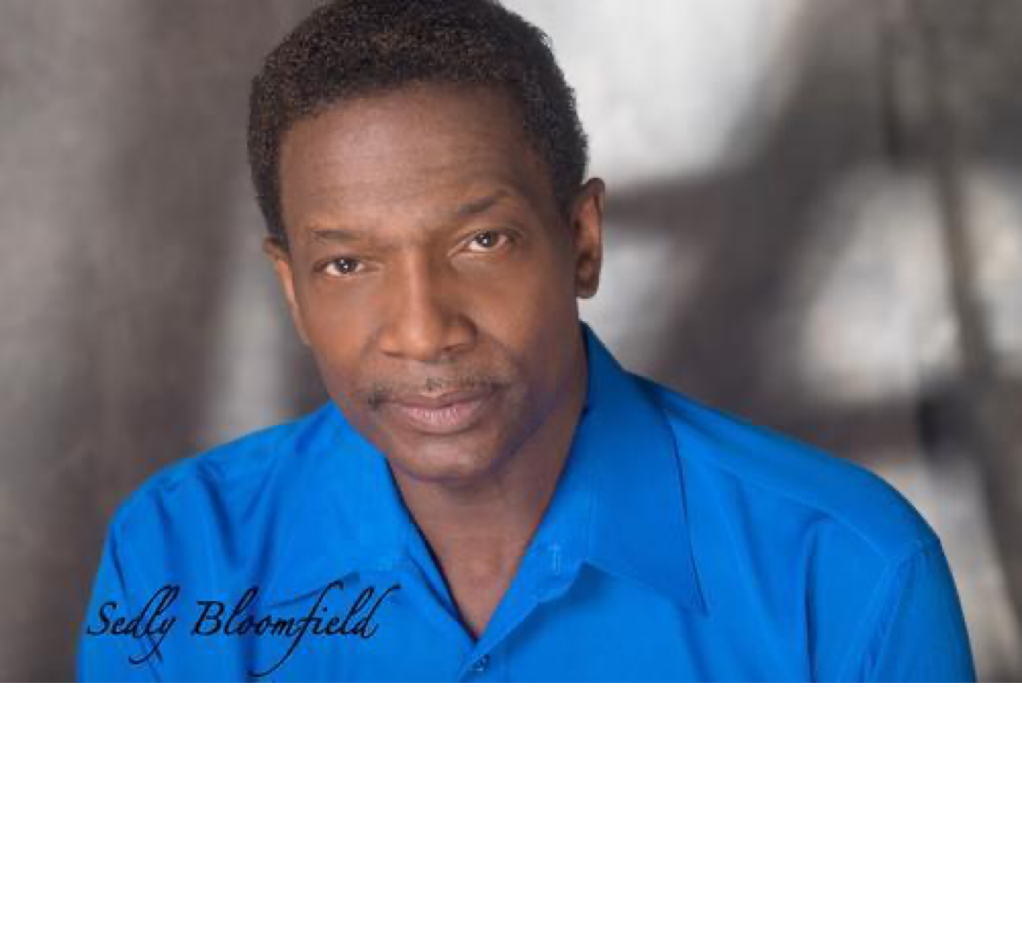 Portrait of Sedly Bloomfield in a blue shirt